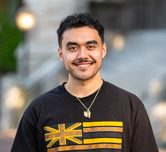 Woman in a t-shirt with a star on it leans against a railing